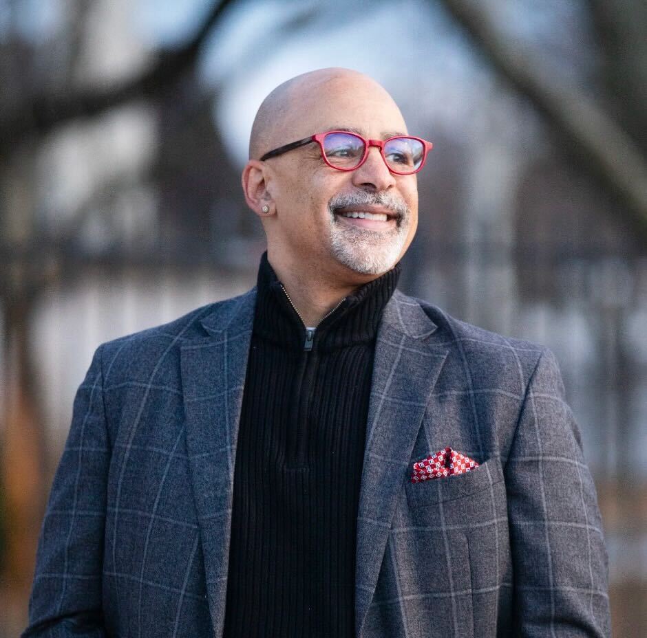 Image of a man smiling in a blazer